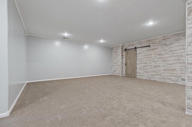 531 Depree Way, Glenwood, MN 56334 - below grade area featuring a barn door, carpet floors, baseboards, ornamental molding, and recessed lighting