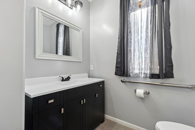531 Depree Way, Glenwood, MN 56334 - half bathroom featuring vanity, baseboards, and toilet
