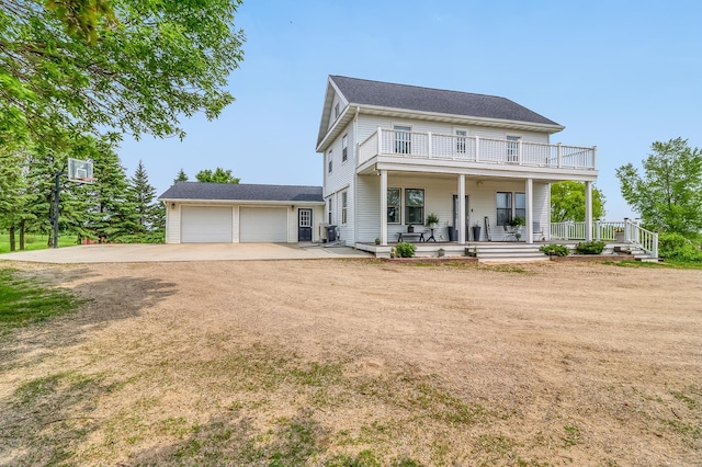 1782 225th St N, Hawley, MN 56549 - view of front of home with a balcony, dirt driveway, and a porch
