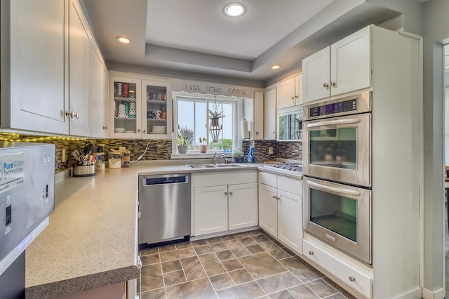 1782 225th St N, Hawley, MN 56549 - kitchen with appliances with stainless steel finishes, a sink, tasteful backsplash, white cabinetry, and light countertops