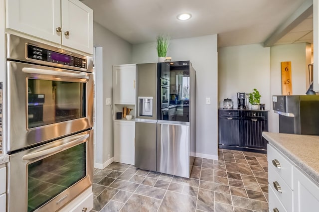 1782 225th St N, Hawley, MN 56549 - kitchen with appliances with stainless steel finishes, white cabinets, light countertops, and baseboards