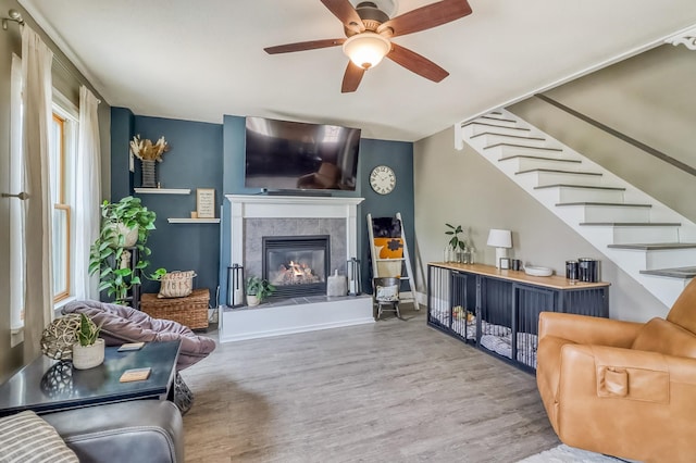 1782 225th St N, Hawley, MN 56549 - living room with wood finished floors, stairway, ceiling fan, and a tile fireplace