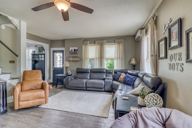 1782 225th St N, Hawley, MN 56549 - living area with a wall unit AC, ceiling fan, and wood finished floors