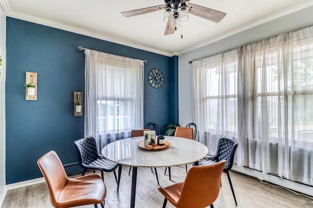 1782 225th St N, Hawley, MN 56549 - dining room featuring ceiling fan, wood finished floors, crown molding, and a baseboard heating unit
