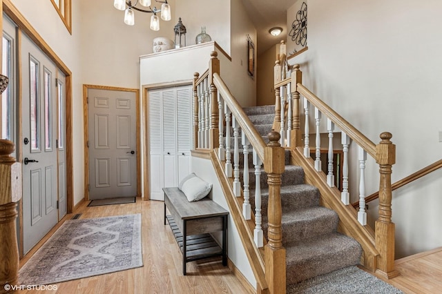 21857 Iden Avenue Pl N, Forest Lake, MN 55025 - foyer with wood finished floors, a towering ceiling, a chandelier, baseboards, and stairs