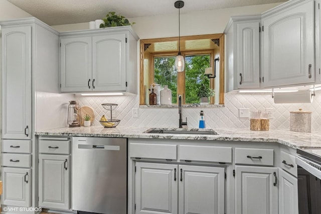 21857 Iden Avenue Pl N, Forest Lake, MN 55025 - kitchen featuring appliances with stainless steel finishes, a sink, tasteful backsplash, and decorative light fixtures