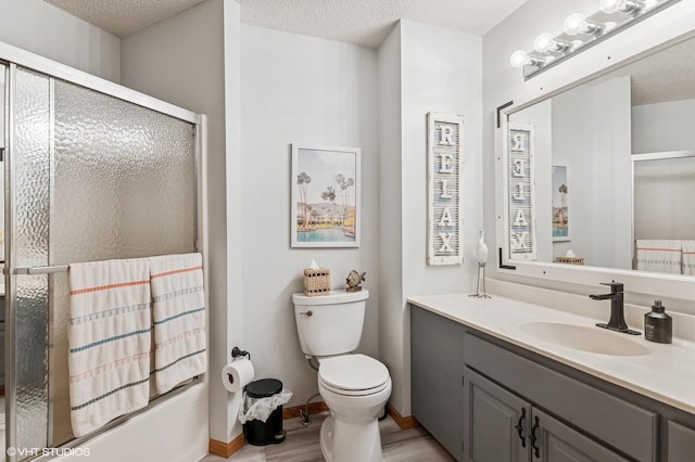 21857 Iden Avenue Pl N, Forest Lake, MN 55025 - full bath featuring a shower with door, vanity, toilet, wood finished floors, and a textured ceiling