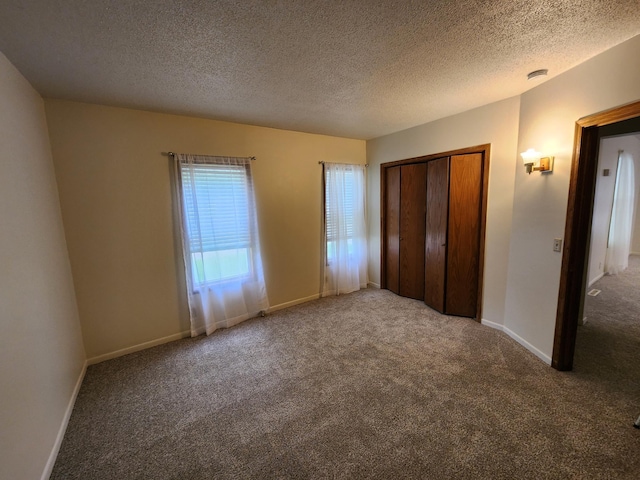 412 3rd St, Monticello, MN 55362 - unfurnished bedroom featuring carpet floors, a textured ceiling, a closet, and baseboards