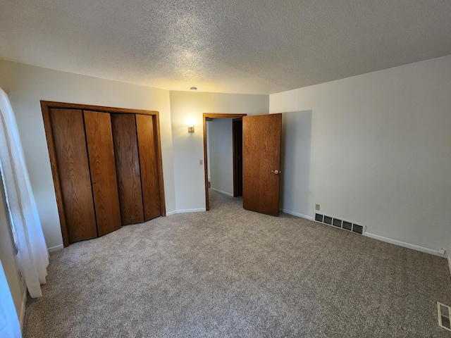 412 3rd St, Monticello, MN 55362 - unfurnished bedroom featuring carpet, a closet, a textured ceiling, and baseboards