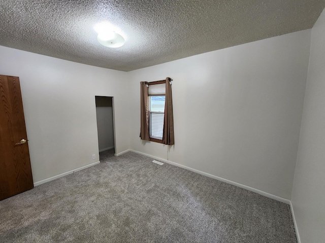 412 3rd St, Monticello, MN 55362 - unfurnished bedroom featuring carpet, a textured ceiling, and baseboards