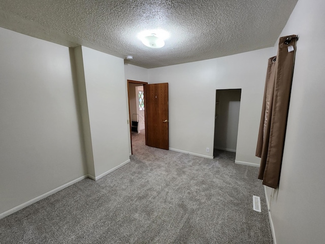 412 3rd St, Monticello, MN 55362 - carpeted empty room featuring a textured ceiling and baseboards