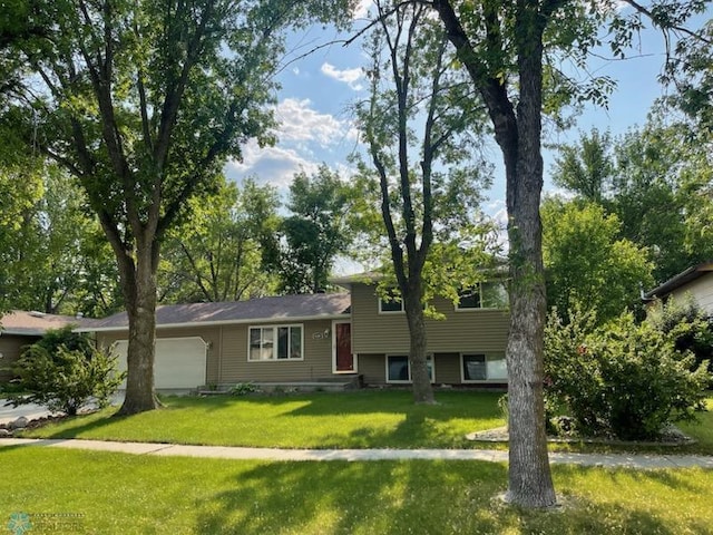 614 8th St E, West Fargo, ND 58078 - tri-level home featuring an attached garage and a front lawn