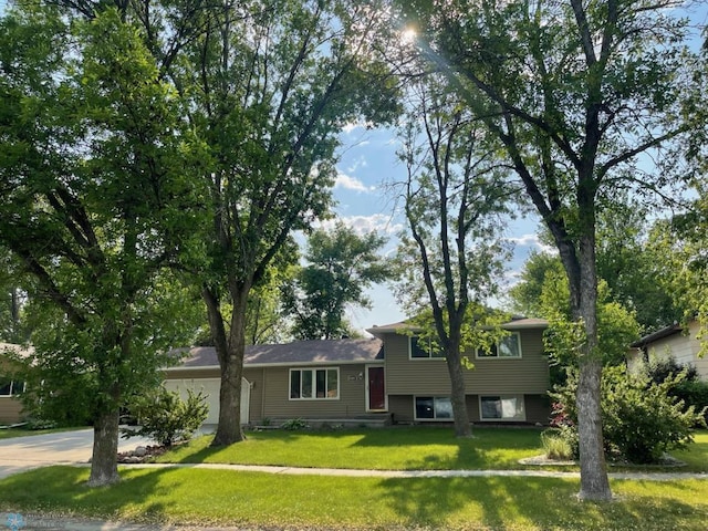614 8th St E, West Fargo, ND 58078 - tri-level home featuring concrete driveway, a front lawn, and a garage