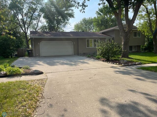 614 8th St E, West Fargo, ND 58078 - tri-level home with an attached garage and concrete driveway