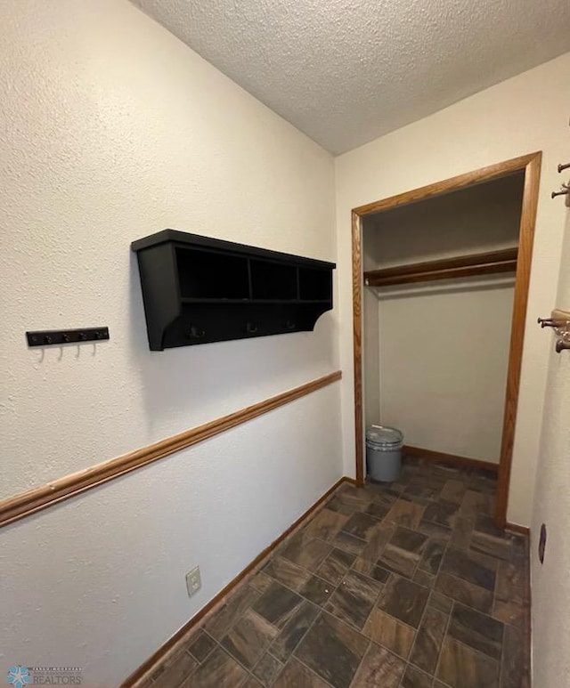 614 8th St E, West Fargo, ND 58078 - corridor with a textured ceiling and baseboards