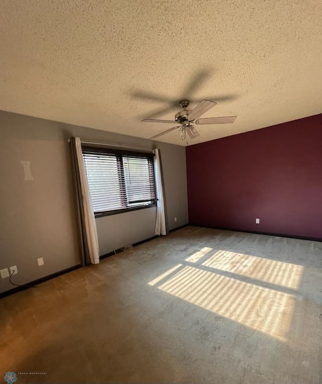 614 8th St E, West Fargo, ND 58078 - unfurnished room featuring light colored carpet, a ceiling fan, a textured ceiling, and baseboards