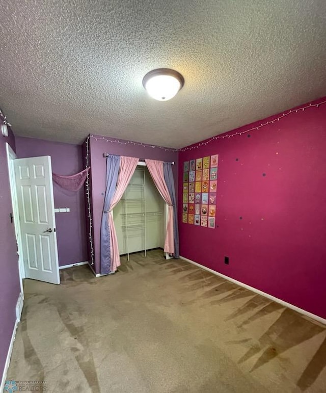 614 8th St E, West Fargo, ND 58078 - unfurnished bedroom with a textured ceiling and carpet floors