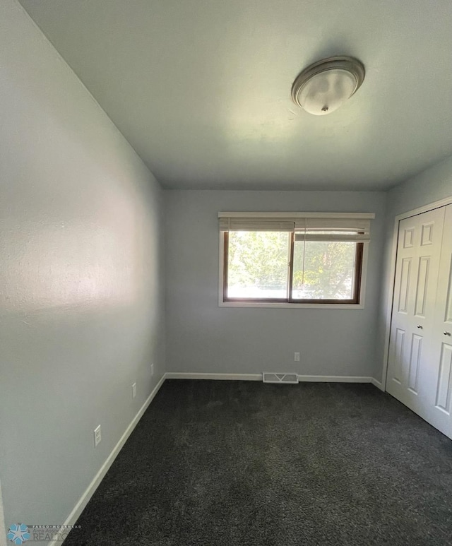 614 8th St E, West Fargo, ND 58078 - unfurnished bedroom featuring dark colored carpet, baseboards, and a closet