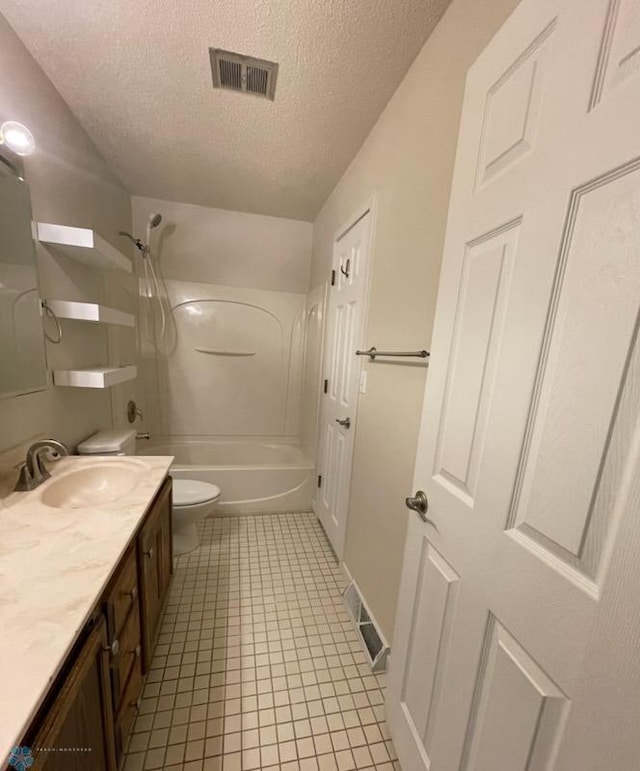 614 8th St E, West Fargo, ND 58078 - bathroom featuring toilet, vanity, a textured ceiling, shower / bathtub combination, and tile patterned flooring