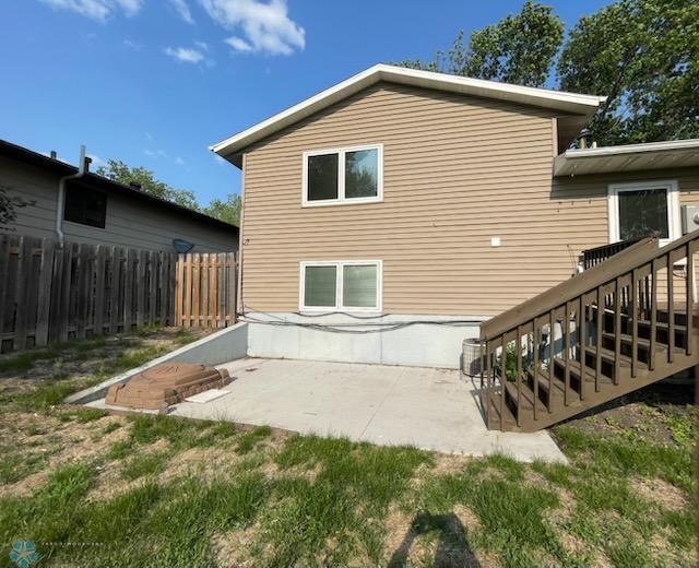 614 8th St E, West Fargo, ND 58078 - back of property featuring a patio and stairway