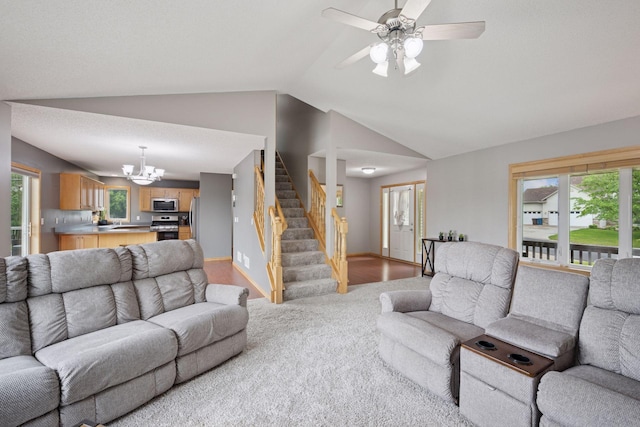 19470 Zumbro Ct NW, Elk River, MN 55330 - living area with lofted ceiling, a chandelier, stairs, light colored carpet, and ceiling fan