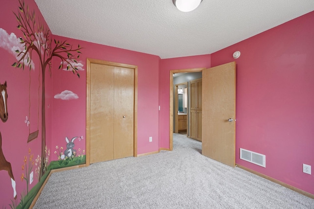 19470 Zumbro Ct NW, Elk River, MN 55330 - unfurnished bedroom featuring carpet flooring, a textured ceiling, a closet, and baseboards