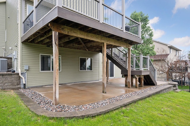 19470 Zumbro Ct NW, Elk River, MN 55330 - back of property with stairs, a patio area, a yard, a wooden deck, and central AC