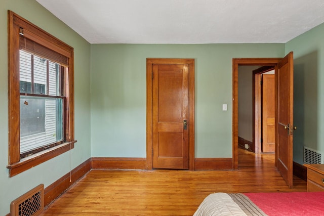 4059 Sheridan Ave N, Minneapolis, MN 55412 - unfurnished bedroom with light wood-style flooring and baseboards