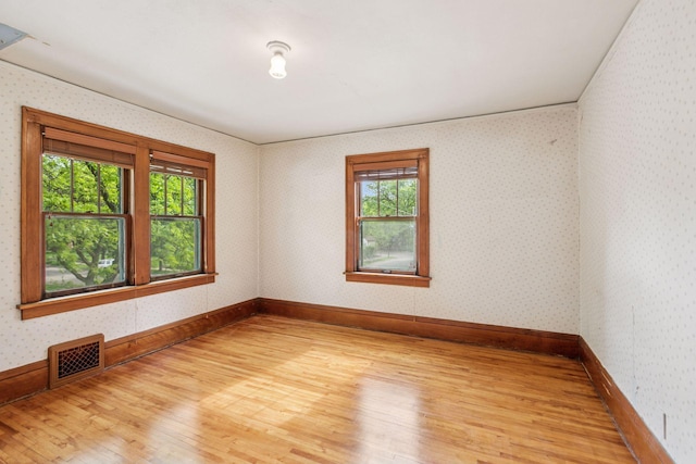 4059 Sheridan Ave N, Minneapolis, MN 55412 - unfurnished room featuring plenty of natural light, light wood-type flooring, and baseboards