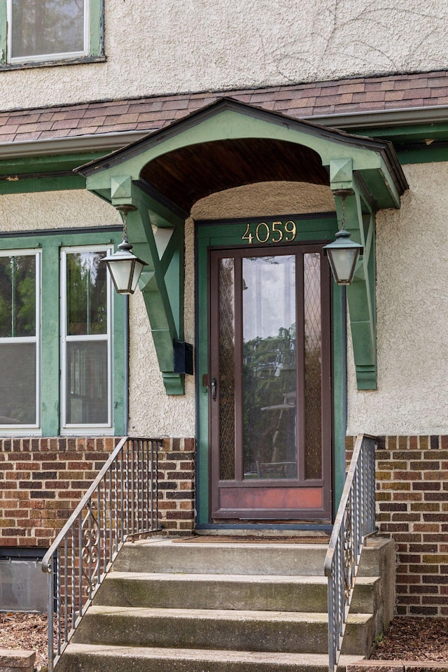 4059 Sheridan Ave N, Minneapolis, MN 55412 - entrance to property featuring brick siding, stucco siding, and roof with shingles