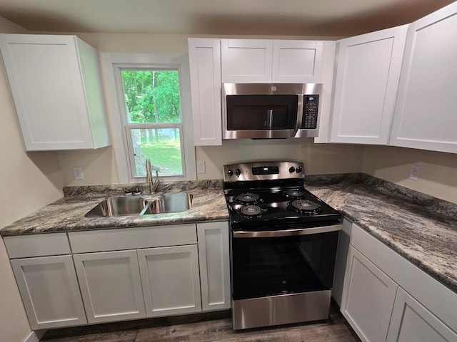 29501 Maplewood Rd Horseshoe, Unit Horseshoe, Callaway, MN 56521 - kitchen featuring appliances with stainless steel finishes, white cabinetry, and dark wood-type flooring