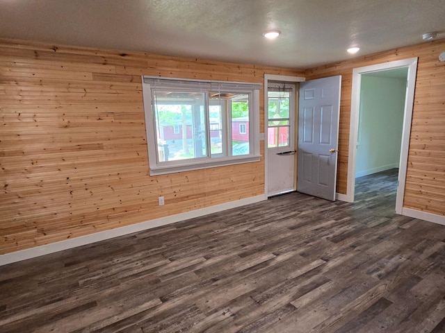 29501 Maplewood Rd Horseshoe, Unit Horseshoe, Callaway, MN 56521 - spare room featuring dark wood finished floors, wood walls, a smoke detector, and recessed lighting