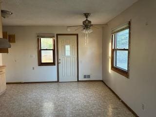 905 Fuller Ave, Saint Paul, MN 55104 - unfurnished dining area with ceiling fan and baseboards