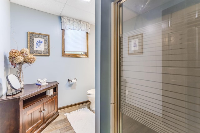 8563 72nd St S, Cottage Grove, MN 55016 - full bath with toilet, baseboards, wood finished floors, a shower with shower door, and vanity