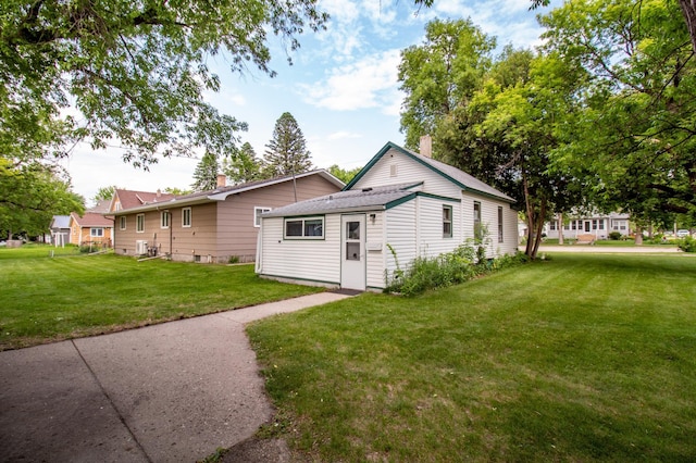 103 3rd St NE, Barnesville, MN 56514 - view of side of property featuring a yard and a chimney