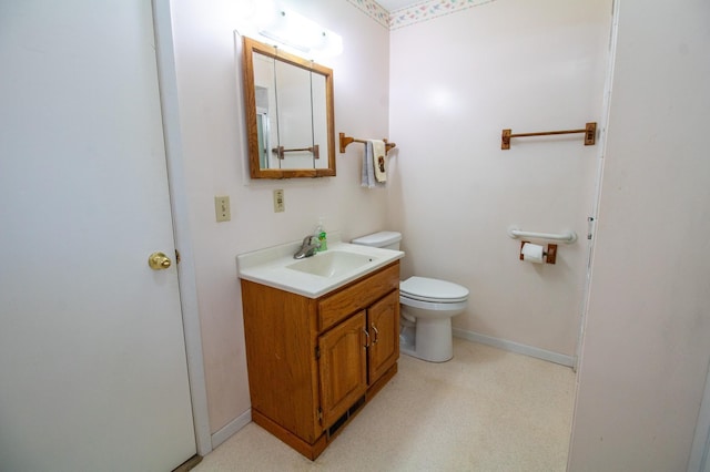 103 3rd St NE, Barnesville, MN 56514 - bathroom with vanity, toilet, and baseboards