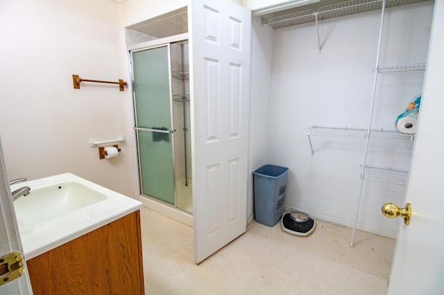 103 3rd St NE, Barnesville, MN 56514 - bathroom featuring a shower stall, vanity, and a spacious closet