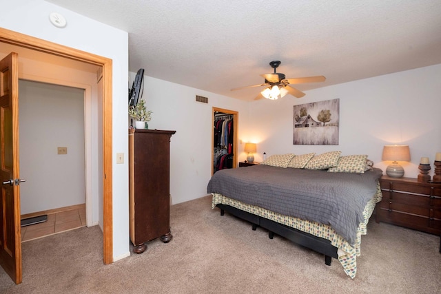 840 Shore Dr W, Orono, MN 55364 - bedroom with a walk in closet, light carpet, a closet, and a ceiling fan
