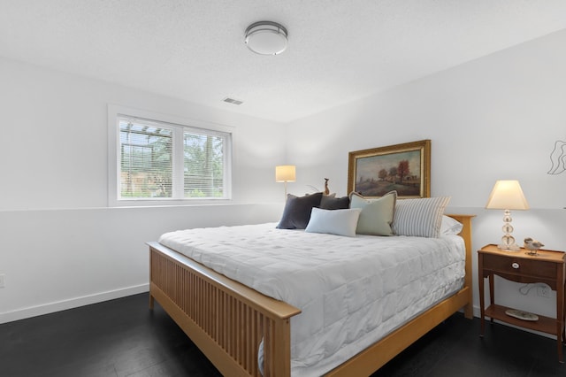 1300 Earle Way, Burnsville, MN 55306 - bedroom featuring baseboards and dark wood-style flooring