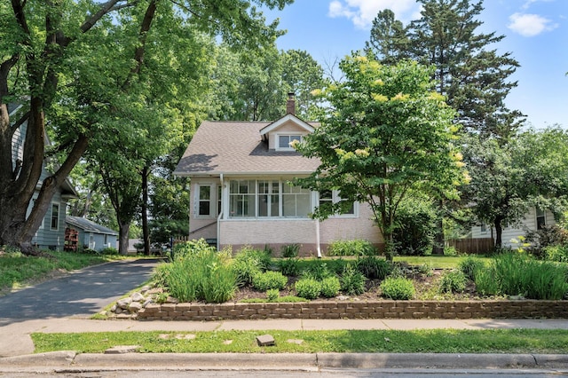 1252 Arkwright St, Saint Paul, MN 55130 - view of front of home with a chimney, brick siding, and asphalt driveway