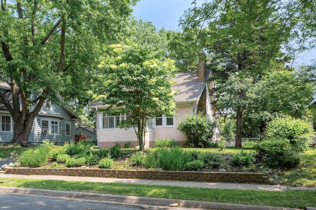 1252 Arkwright St, Saint Paul, MN 55130 - view of front facade with a chimney, brick siding, and roof with shingles