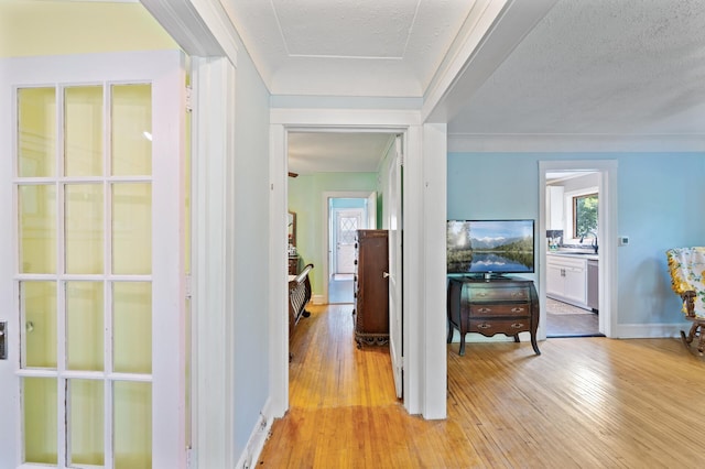 1252 Arkwright St, Saint Paul, MN 55130 - corridor with light wood finished floors and a sink