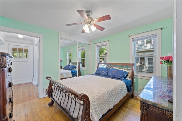 1252 Arkwright St, Saint Paul, MN 55130 - bedroom with light wood finished floors, ceiling fan, and a closet