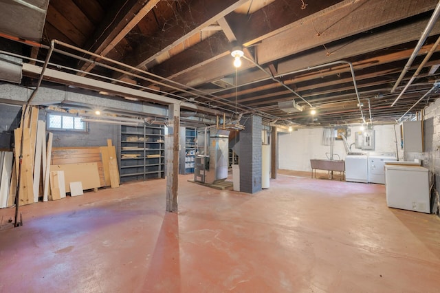 1252 Arkwright St, Saint Paul, MN 55130 - basement featuring washing machine and dryer, electric panel, refrigerator, and heating unit