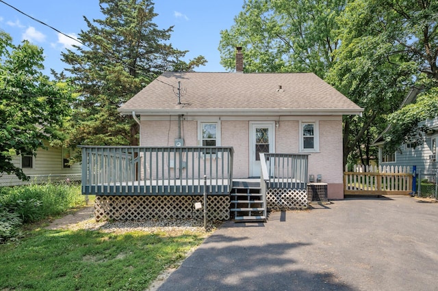 1252 Arkwright St, Saint Paul, MN 55130 - view of front of property featuring a shingled roof, a wooden deck, and a chimney