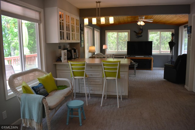31145 409th Pl, Aitkin, MN 56431 - kitchen with vaulted ceiling, glass insert cabinets, white cabinetry, a peninsula, and open floor plan