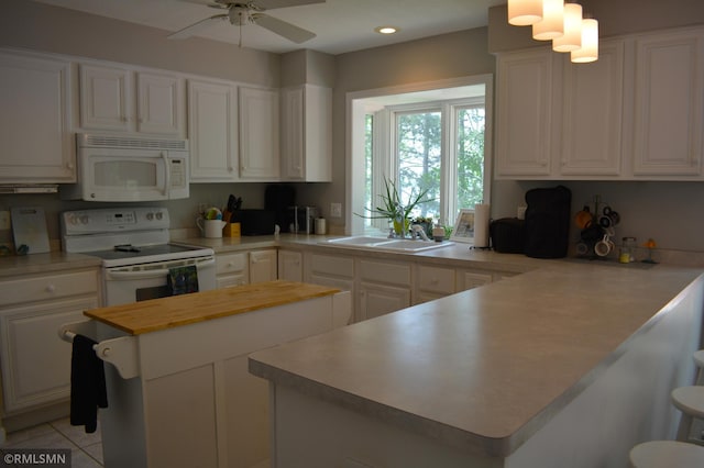 31145 409th Pl, Aitkin, MN 56431 - kitchen with white appliances, wooden counters, white cabinetry, a peninsula, and ceiling fan