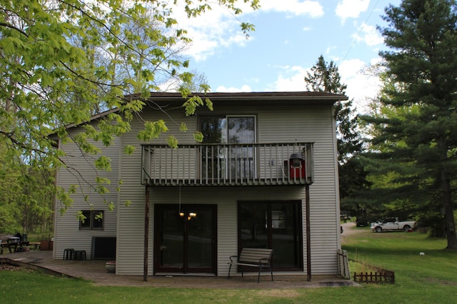 7047 Kingfisher Ln NE, Frohn Twp, MN 56601 - back of house featuring a balcony, a yard, and a patio area