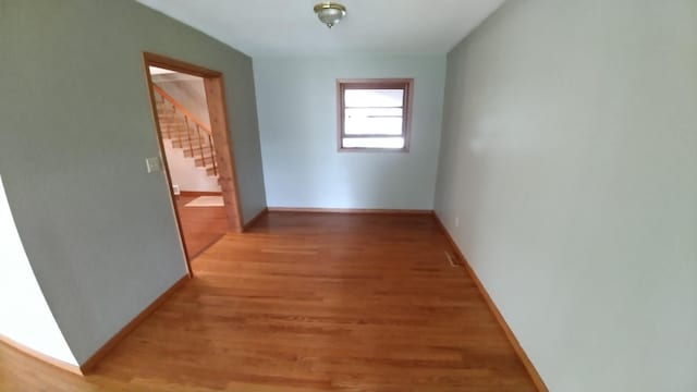 7047 Kingfisher Ln NE, Frohn Twp, MN 56601 - hall with stairway, light wood-style floors, and baseboards