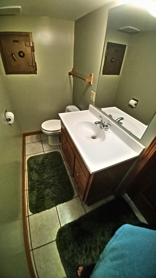 7047 Kingfisher Ln NE, Frohn Twp, MN 56601 - bathroom featuring tile patterned floors, vanity, and toilet